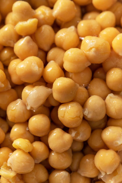 Canned chickpeas upper view. Processed garbanzo beans ready to eat on concrete table. Protein containing food
