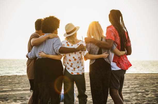 istock Friends watching the sunset at the beach 2158181659