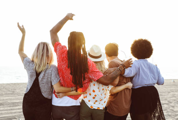 istock Friends watching the sunset at the beach 2158181671