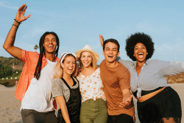 istock Group of diverse friends hanging out at the beach 2158181748