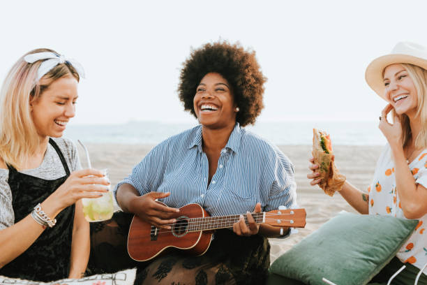 istock Friends singing together at a beach picnic 2158182008