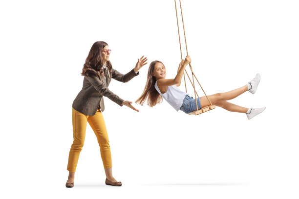 istock Woman pushing girl on a swing 2158182194