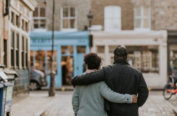 istock African-American couple hugging, walking in city 2158183444