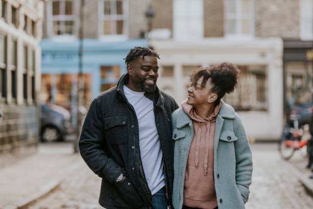 istock African-American couple hugging, walking in city 2158183457