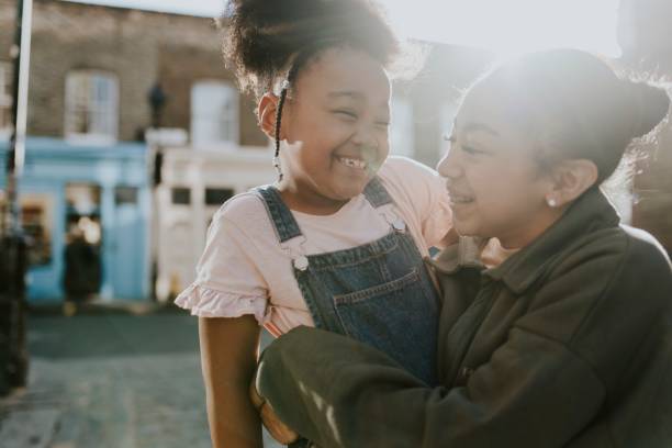 istock Older sister carrying her sibling 2158183494