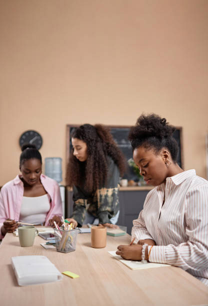 istock Three Multiethnic Women at Desk Having Lesson 2158183742