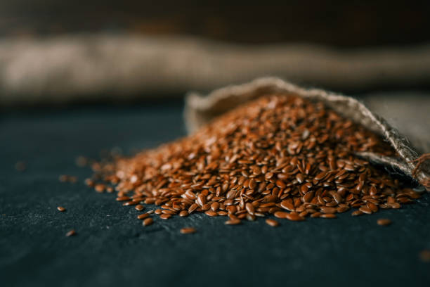 istock Flax seeds spill out of a burlap bag 2158183888