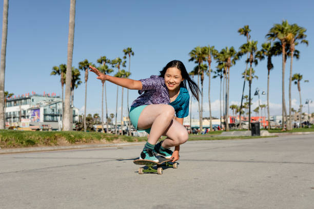istock Happy girl skateboarding, fun outdoors sport activity 2158184692