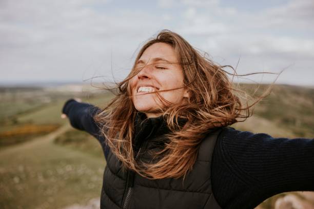 istock Smiling woman spreading arms, outdoor activity 2158185698