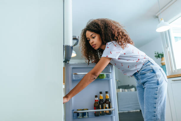 istock Woman opening the fridge in her home 2158185997