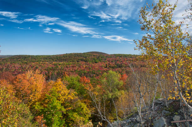 An aerial view of the mountains around becket quarry in massachusetts on an autumn day.