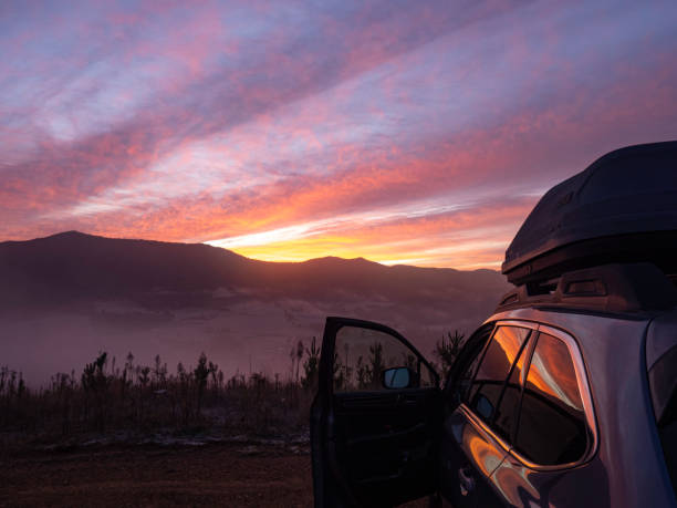 istock Car with door open looking at sunrise mountain views 2158187702