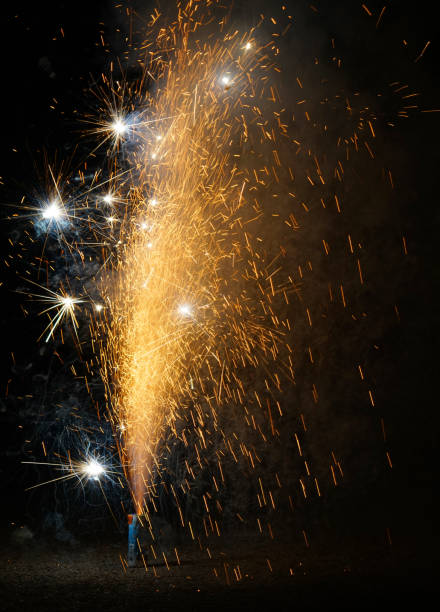 colorful fountain fireworks stream into dark night