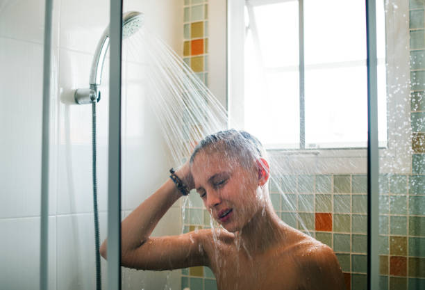 istock Young caucasian man showering in bathroom 2158188939