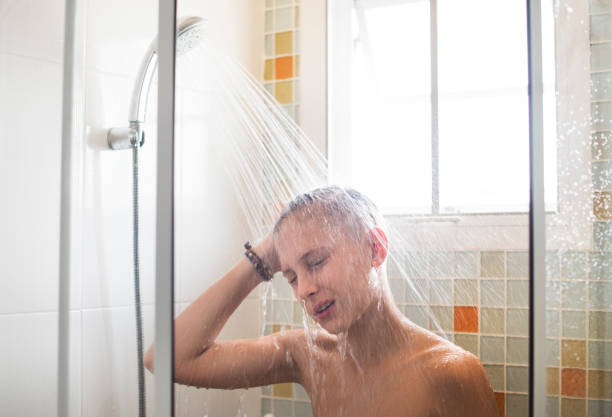 istock Young caucasian man showering in bathroom 2158189035