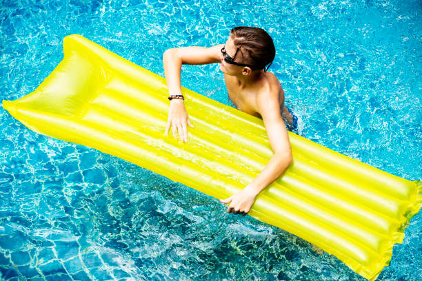 istock Young caucasian boy enjoying the pool 2158189069