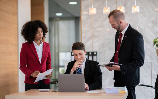 Diverse business team reviewing documents at office desk, Concept of teamwork