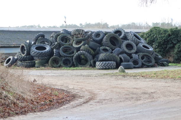 istock Worn tires in a rural setting under a cloudy sky symbolize waste and environmental impact 2158189789