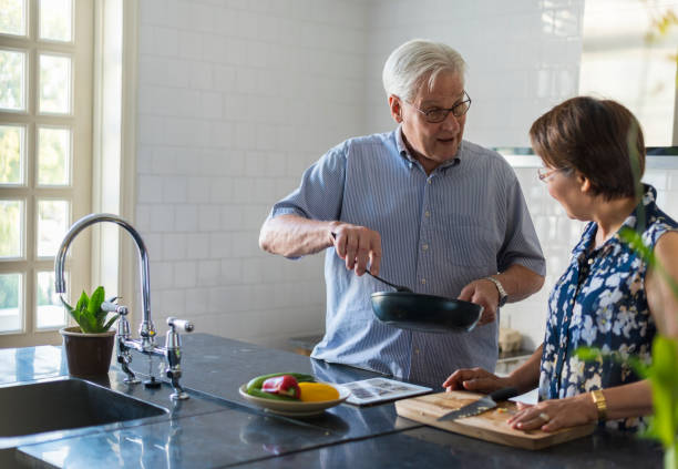 istock Elderly couple cooking together 2158189929