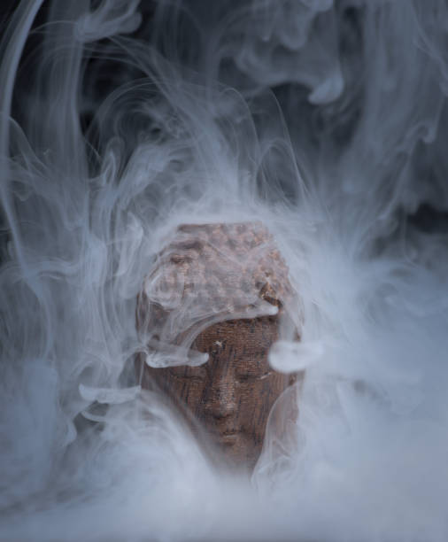 Buddha head with mist and surreal swirling smoke and fog effects handmade by photographer