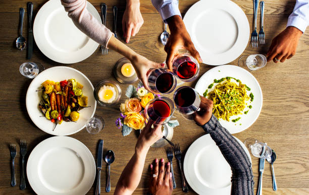 istock People Clinging Wine Glasses Together in Restaurant 2158191105
