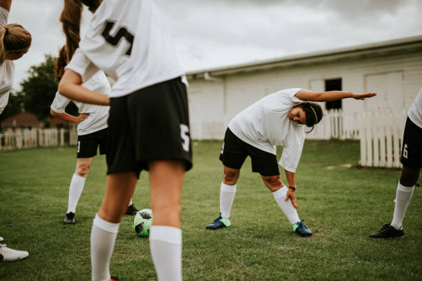 istock Female soccer team players stretching pre game 2158192137