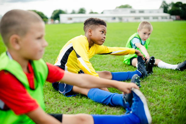 istock Diverse kids stretching on the field 2158192303