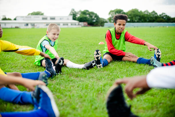 istock Diverse kids stretching on the field 2158192361