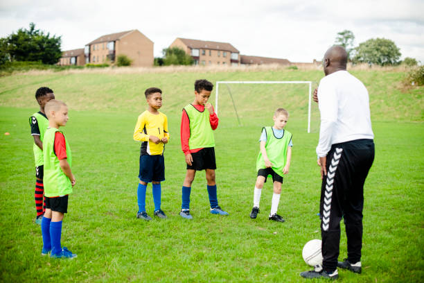 istock Football coach training his junior players 2158192375