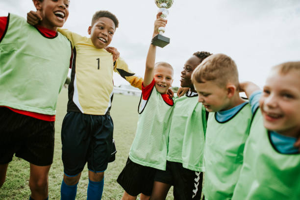 istock Young kids on the field celebrating their victory 2158192400
