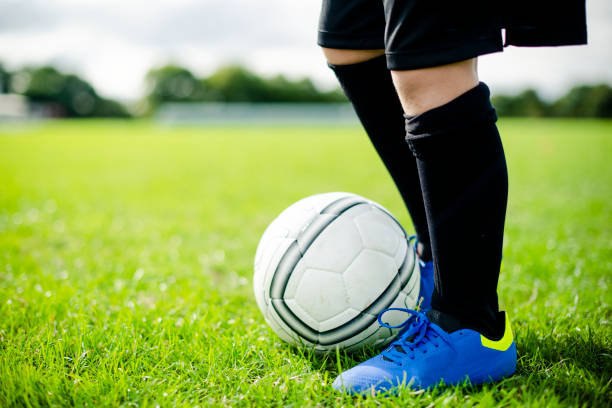 istock Junior football player on the field 2158192406