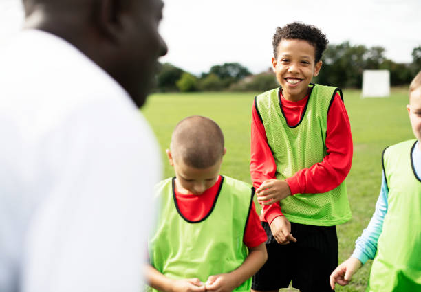 istock Football coach training his students 2158192504