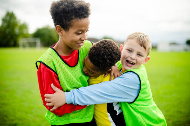 istock Junior football team hugging each other 2158193774