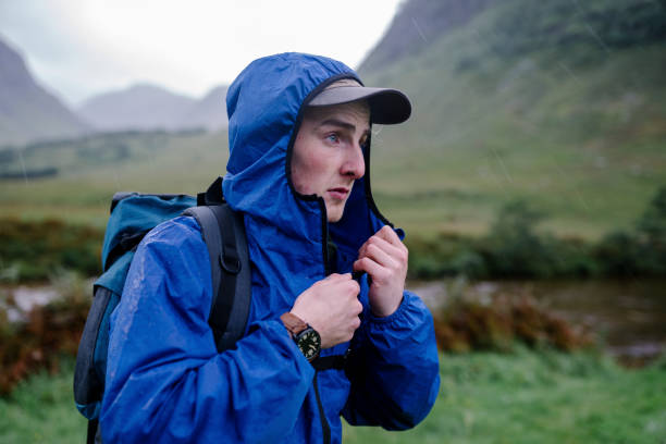 istock Man zipping up his jacket in the cold 2158193912