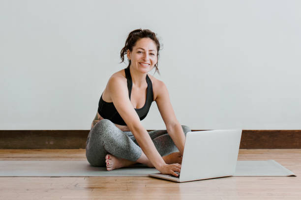 istock Active woman learning yoga online via a laptop 2158193993