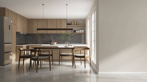 istock Blank beige wall to modern, luxury kitchen with dining table, chairs, wooden cabinet, cupboard, white top island and gray stone splash back 2158194089