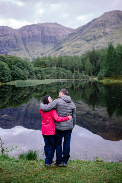 istock Couple hugging by the riverside in the Highlands 2158194181