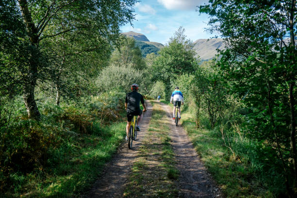 istock Group of cyclists riding through the forest 2158194312