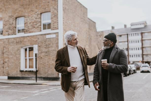 istock Friends walking down street in British town 2158194510