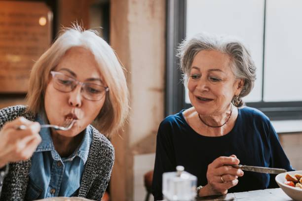 Diverse friends eating lunch at restaurant