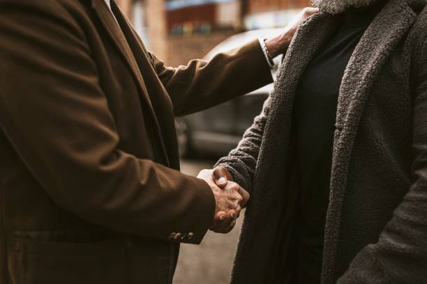 istock Two men shaking hands in the street 2158194550