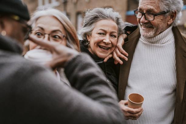 istock Friends drinking coffee from paper cups 2158194636