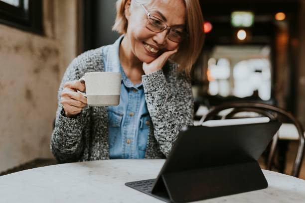 istock Grandmother in video call on digital tablet at cafe 2158194662
