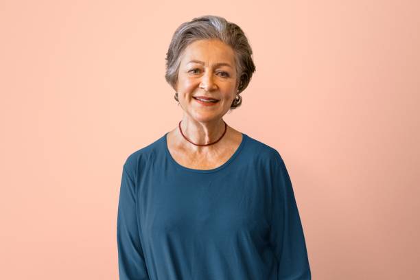 istock Happy senior woman, isolated on peach 2158195114