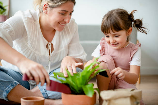 istock Kid DIY plant potting with mom at home 2158197757