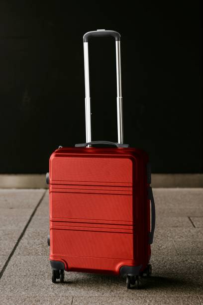 istock Red travel luggage on floor photo 2158197949