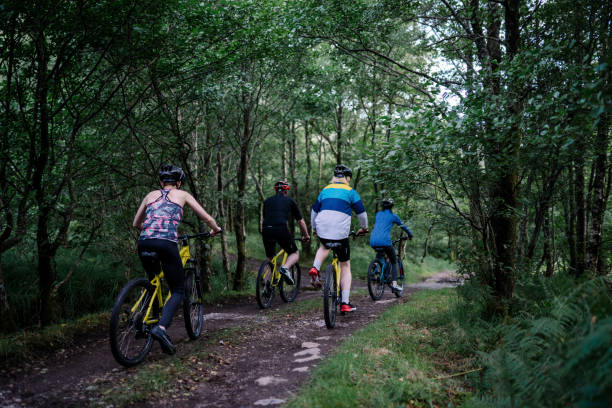 istock Group of cyclists riding through the forest 2158198277
