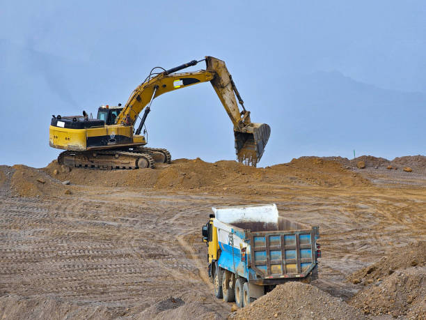 istock Excavator and dump truck type construction machinery building earth platform 2158198282