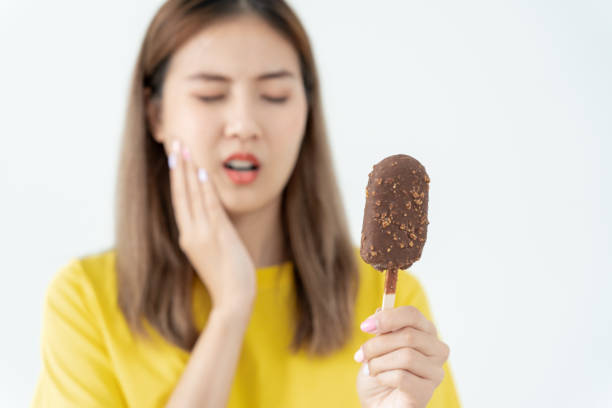 istock Asian woman feel sensitive teeth after eating ice cream, female suffer tooth, decay problems, dental care, tooth extraction, decay problem, bad breath, Gingival Recession, Oral Hygiene instruction 2158199021