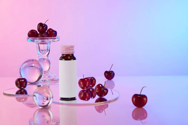 istock The photo of promotional on gradient background, from front view. Empty label bottle, glassware and sweet cherries featured on the left side, blank right side for product placement 2158199322